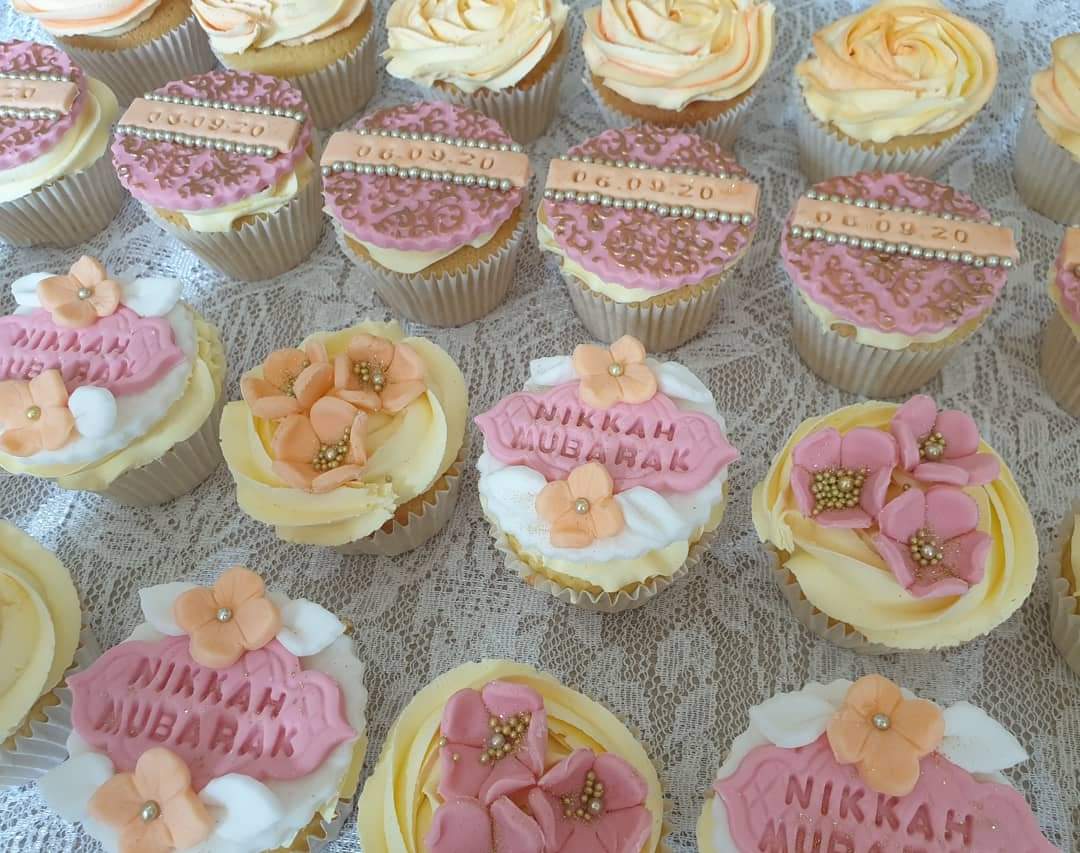 A box of twenty-four beautiful vanilla pastel coloured cupcakes decorated with hand made flowers and plaques. Perfect gift or perfect touch to any event table. 