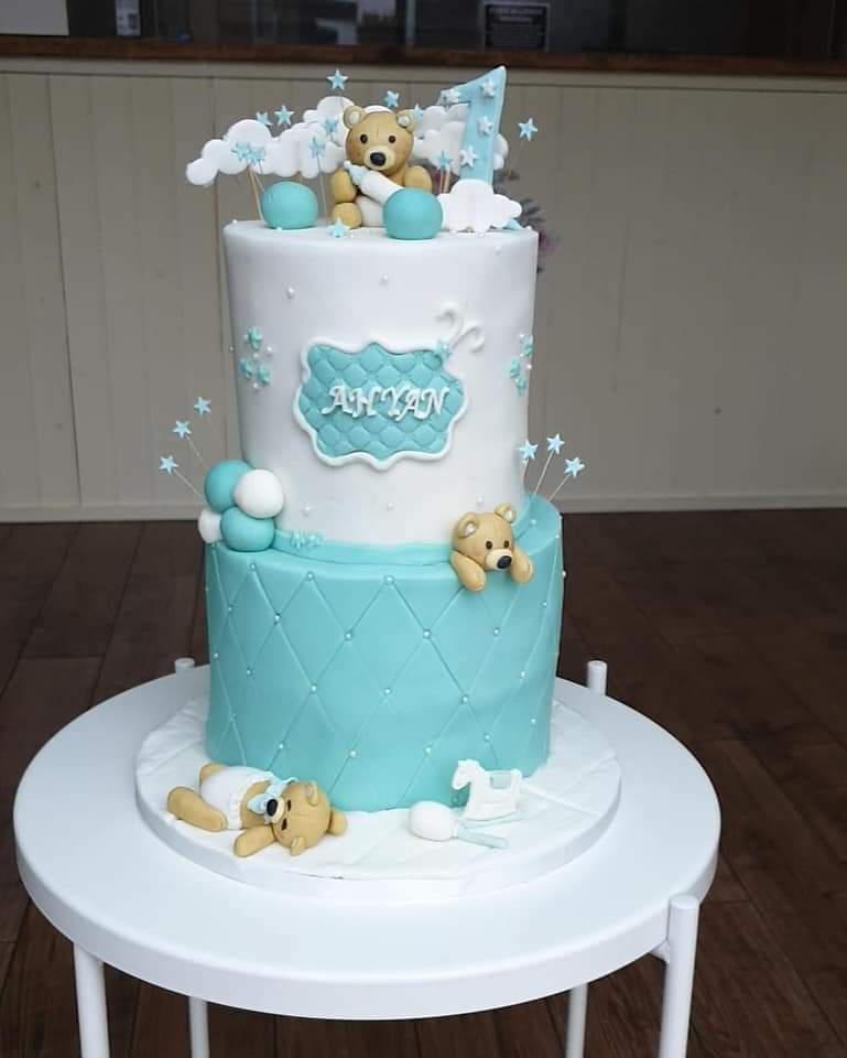 A two tiered eight inch cake designed for a very special boy that turns one years old.  cake is made up of four vanilla sponges filled with buttercream and strawberry jam. Chocolate ganache topped with icing.